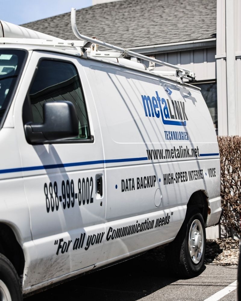 MetaLINK Technologies service van parked outside with company branding and equipment visible