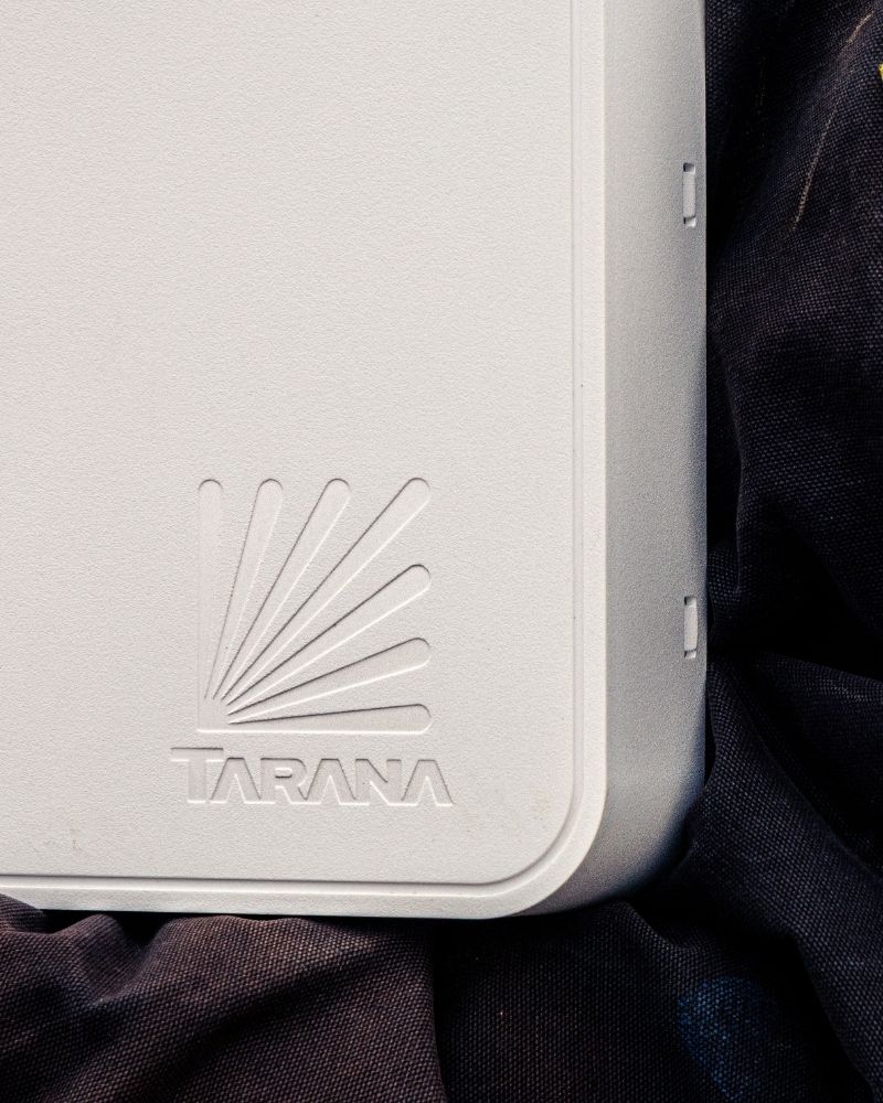 Close-up of MetaLINK internet equipment next to an American flag patch on technician uniform