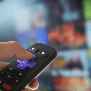 Hand using a Roku remote in front of a streaming TV interface, representing MetaLINK’s flexible internet and TV service options