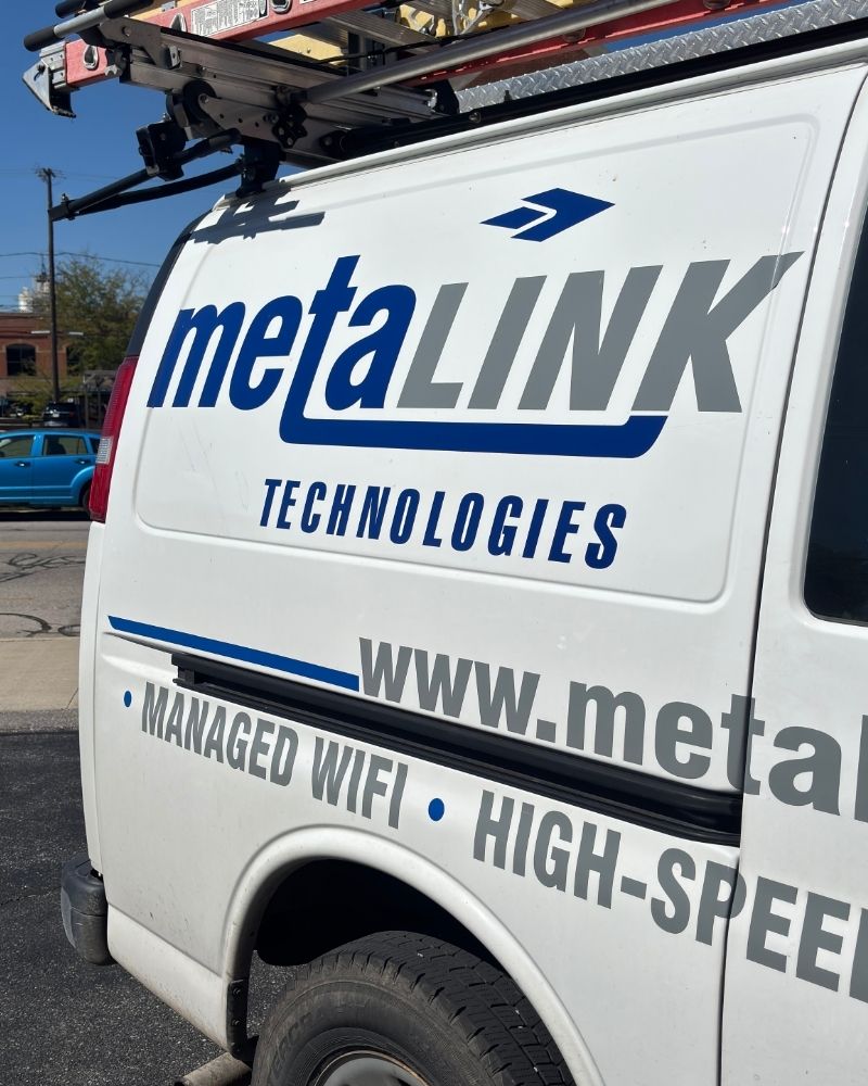 MetaLINK Technologies service van parked outside with company logo and high-speed internet branding