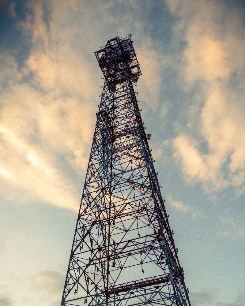 Tall MetaLINK wireless internet tower standing against a colorful sunset sky