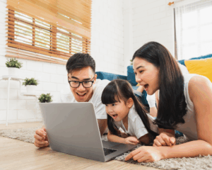 Happy family watching a show together on a laptop using MetaLINK high-speed internet