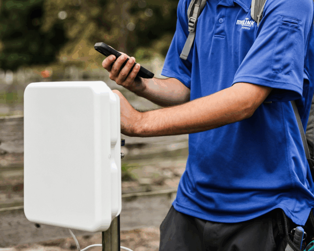 MetaLINK technician installing fixed wireless internet equipment in a rural area