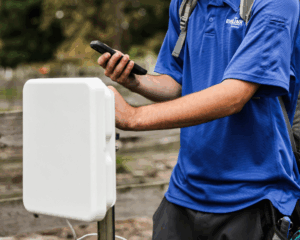 MetaLINK technician installing fixed wireless internet equipment in a rural area