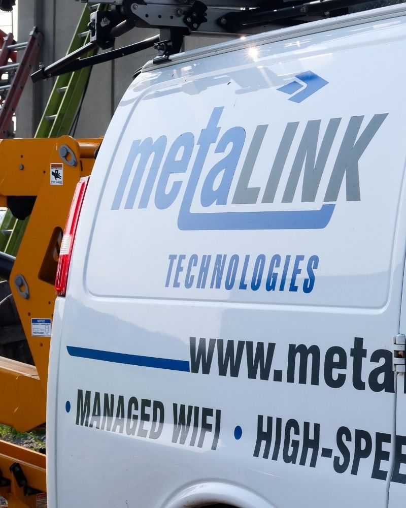 MetaLINK Technologies service van parked on-site for high-speed internet and managed WiFi installation.