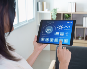 Person using a tablet to manage smart home settings with MetaLINK internet connectivity