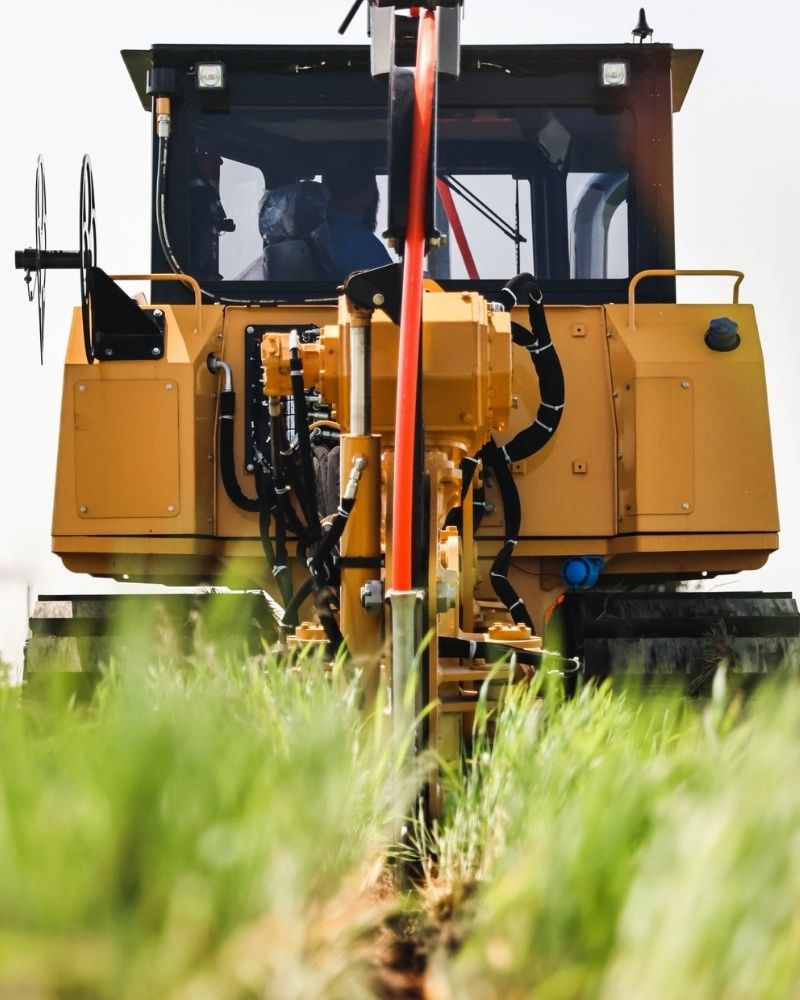 Trenching equipment laying underground fiber-optic cable for MetaLINK internet service