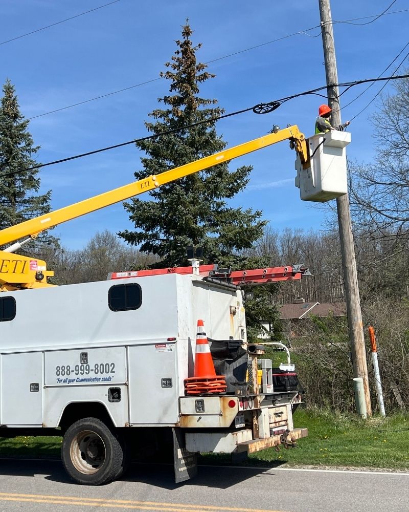 MetaLINK crew member working from a bucket truck during aerial fiber installation in Payne, Ohio