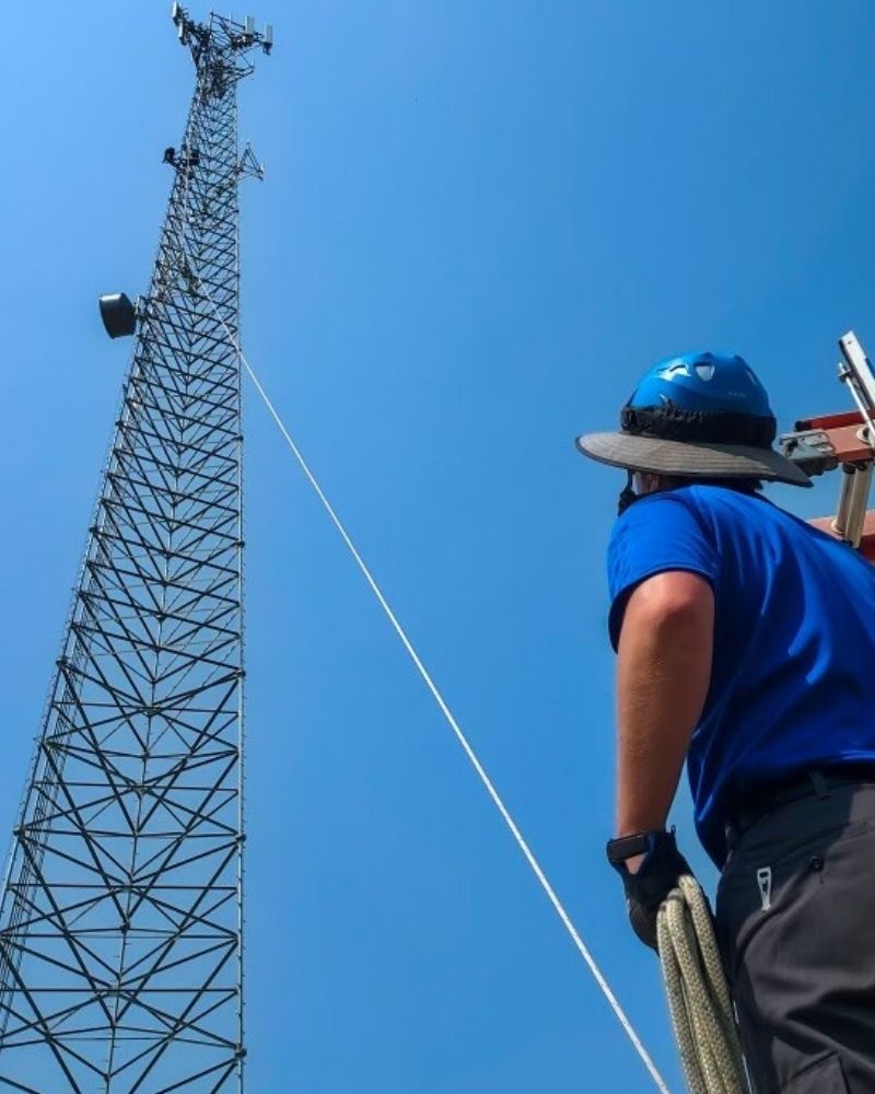 MetaLINK technician preparing to climb a wireless internet tower during upgrade