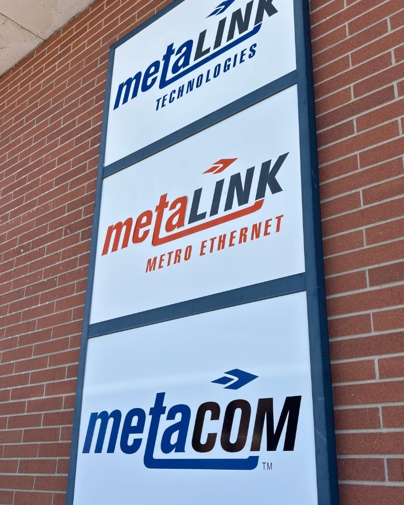 MetaLINK Technologies building signage on exterior wall, highlighting a locally owned internet and TV provider