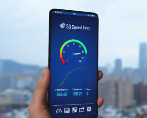 Smartphone displaying an internet speed test app with download, upload, and ping results, representing high-speed internet performance, broadband connectivity, and network speed testing.