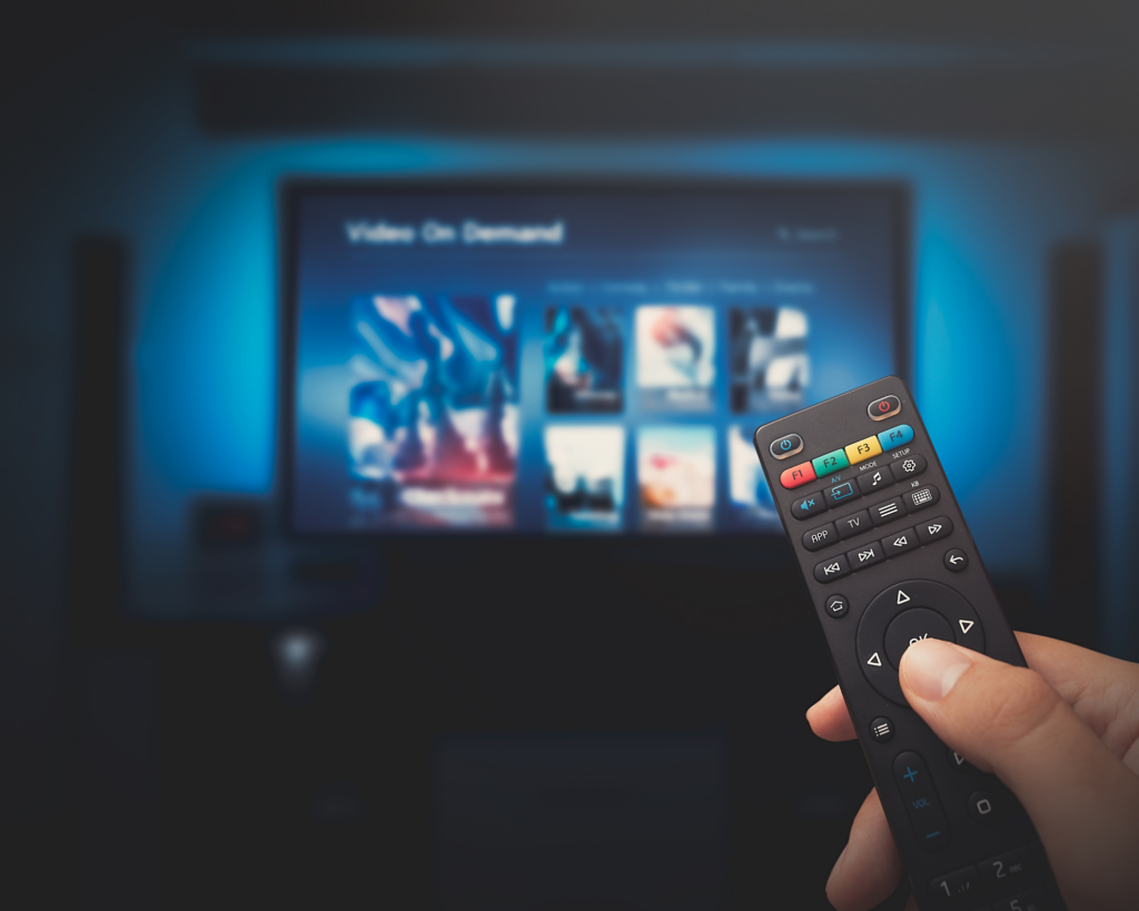 Remote control pointing toward a television streaming on-demand entertainment with MetaLINK TV service.